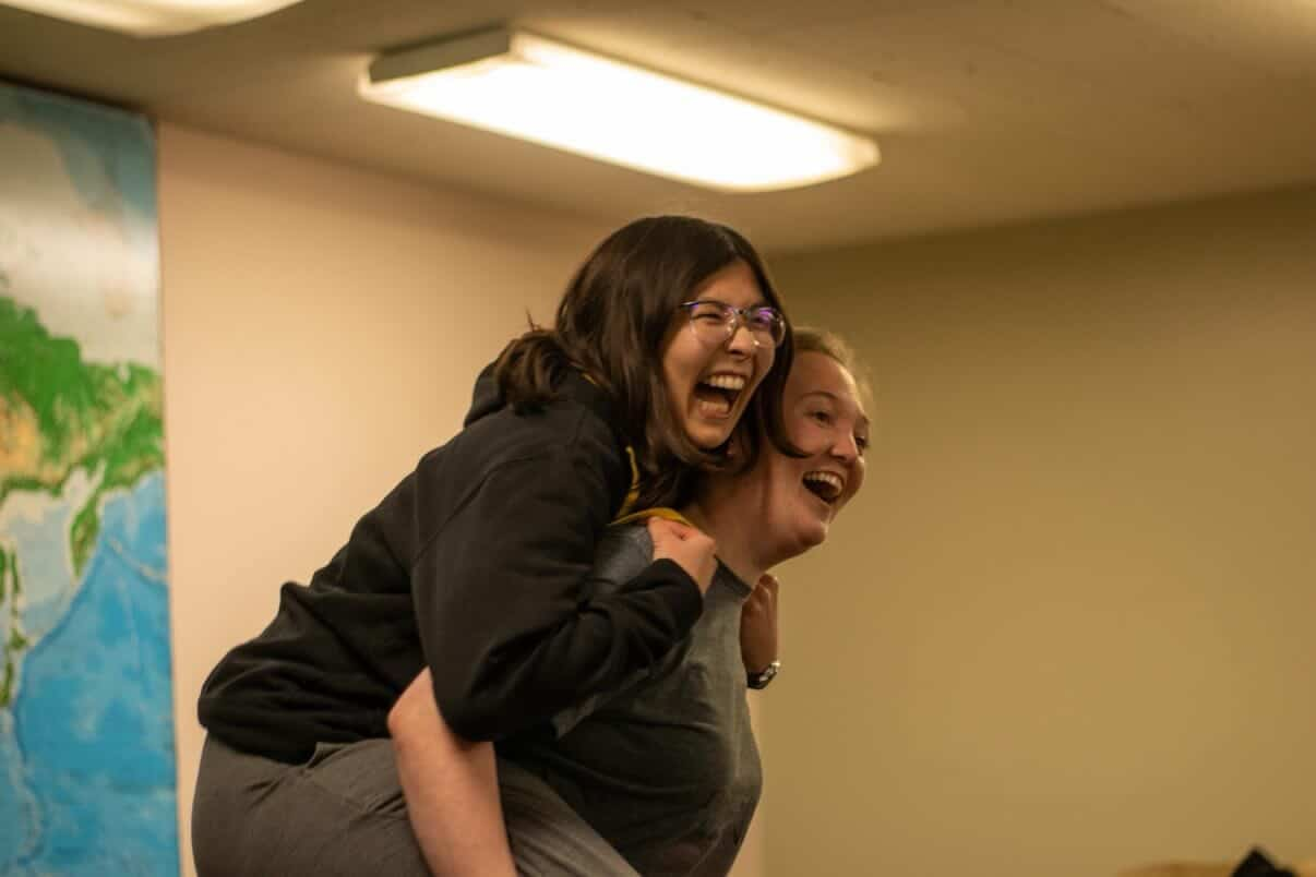 Two friends sharing an unfiltered moment of joy